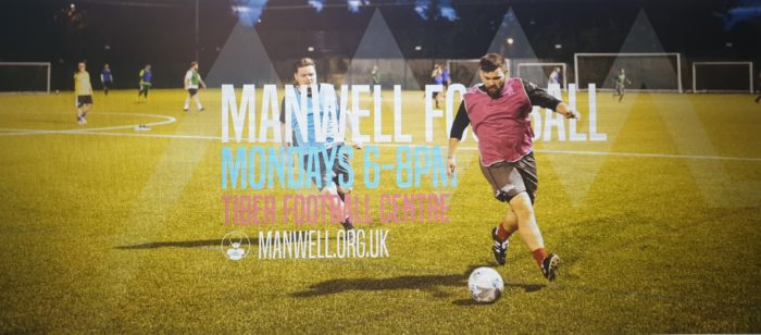 Two men on a football pitch with the text 'Manwell FC Mondays 6pm Tiber Football Centre Manwell.org.uk overlayed on top.